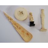 AN EARLY TWENTIETH CENTURY IVORY SHOEHORN WITH FIGURAL HANDLE, AN EARLY TWENTIETH CENTURY IVORY