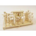 EARLY TWENTIETH CENTURY CARVED IVORY GROUP OF A PALANQUIN WITH TWELVE ATTENDANTS, the litter with