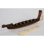 A CARVED BONE SHOEHORN, WITH ENGRAVED INSECTS, REPTILES AND BIRD AND A WOODEN MODEL OF A