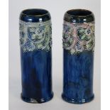 PAIR OF ROYAL DOULTON MOULDED POTTERY VASES, of cylindrical form, each decorated in tones of pink,