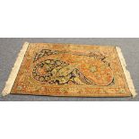 EASTERN RUG,  with a design of large scrolled cones in pink and pale green on a midnight blue field,