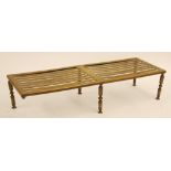 ANTIQUE PIERCED BRASS LARGE TRIVET/HEARTH STAND, of oblong slatted form with six turned supports (