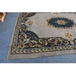 PROBABLY EARLY TWENTIETH CENTURY DONEGAL CARPET, with a plain pale blue field, with dark blue  and