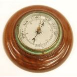 TWENTIETH CENTURY MAHOGANY CASED ANEROID BAROMETER, with silvered dial and turned case, 7 1/4" (18.