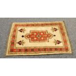 EASTERN PRAYER RUG, the rectangular centre panel  red with a foliate pattern, a fawn field with four