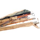 NINE BYGONE FISHING RODS, in canvas holders, including; Pel Tack Ostee 359 TOGETHER WITH FOUR BYGONE