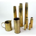 NINE MILITARY BRASS SHELL CASES, comprising; 3 pairs and another floral engraved and inscribed '