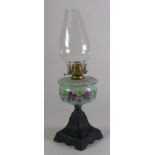 VICTORIAN CAST IRON AND FLORAL PAINTED OPAQUE GLASS OIL TABLE LAMP, typical form with clear glass