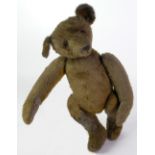 PROBABLY GERMAN, AGED PALE GOLD PLUSH TEDDY BEAR, with felt pads, humped back and original glass