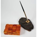 AN AMBER TILED TABLE CIGARETTE BOX, with hinged top and hardwood lined interior, 5 1/4" x 3 1/2" (