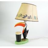 CARLTONWARE CHINA, GUINNESS TOUCAN ADVERTISING TABLE LAMP WITH ORIGINAL PRINTED SHADE, modelled as a