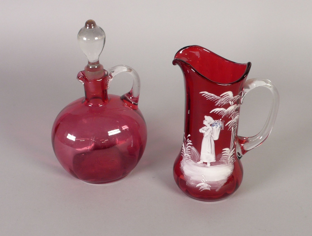 MARY GREGORY STYLE CRANBERRY GLASS JUG, of cylindrical form with swollen base and clear glass loop