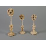 THREE LATE NINETEENTH/EARLY TWENTIETH CENTURY CHINESE CARVED IVORY CONCENTRIC BALLS on figural