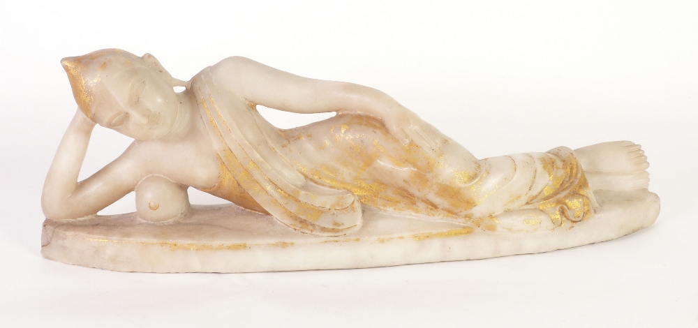 A NINETEENTH CENTURY INDIAN OR BURMESE CARVED ALABASTER FIGURE of a reclining Buddha, traces of