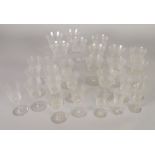 TWENTY EIGHT PIECE PART TABLE SERVICE OF STEMMED DRINKING GLASSES, with wriggle engraved borders,