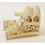 EARLY TWENTIETH CENTURY CARVED IVORY GROUP OF AN OX-DRAWN CART CARRYING TWO FIGURES, WITH DRIVER,