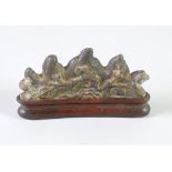 A NINETEENTH CENTURY CHINESE FERRUGINOUS  METAL BRUSH REST, cast in the form of four mountain