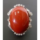 LARGE CORAL AND DIAMOND SET RING, large oval coral 2.7cm long, WITH DIAMOND SET SCROLL FRAME, 28