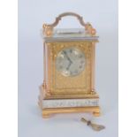 A 20TH CENTURY ORNATE CARRIAGE CLOCK with engraved Roman silvered dial set in the rectangular gilt