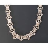 LATE VICTORIAN SILVER CHAIN NECKLACE, formed of alternating open work bead and three-bar links, with