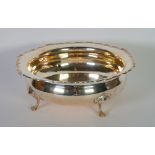 SILVER FRUIT BOWL circular and bulbous with flat rim having raised cyma edge, and raised on four paw