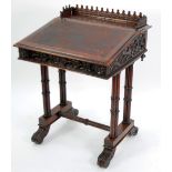 A LATE NINETEENTH CENTURY CARVED OAK GOTHIC/ECCLESIASTICAL DESIGN SLOPE TOP DESK, raised on