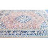 INDIAN HAND MADE SMALL CARPET, with a large repeated foliate medallion pattern and large foliate