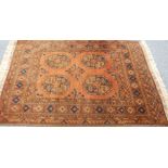 FINE AFGHAN RUG, with four large octagonal guls on a brick red field, multiple border stripes,