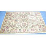 HAND MADE INDIAN RUG, with a design of nine large stylised flowers and large foliate scrolls, on a