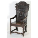 LATE SEVENTEENTH CENTURY AND LATER CARVED OAK WAINSCOT CHAIR, the scroll top rail carved with a pair