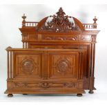 VERY ORNATE LATE 19TH CENTURY CONTINENTAL CARVED WALNUT WOOD DOUBLE BEDSTEAD, the headboard with