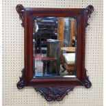 NINETEENTH CENTURY COMPOSITE CARVED MAHOGANY WALL MIRROR, the roundels, oblong, bevel edged plate