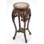 EARLY TWENTIETH CENTURY CHINESE CARVED PADOUK AND MARBLE JARDINERE STAND, the circular top with pink