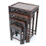 NEST OF FOUR CHINESE CARVED PADOUK OCCASIONAL TABLES, each with inset oblong top, foliate carved