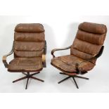 PAIR OF EAMES STYLE LOUNGE CHAIRS, upholstered in brown leather (distressed) and with rosewood
