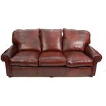 COSTLY MODERN BROWN LEATHER THREE SEATER SETTEE AND A MATCHING FOOT STOOL on turned supports and the