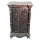 LATE NINETEENTH CENTURY ANGLO INDIAN PROFUSELY CARVED HARDWOOD BOW FRONTED SIDE CABINET, the