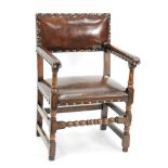 EARLY 18TH CENTURY STYLE OAK OPEN ARM CHAIR/CARVERS CHAIR with brass studded brown hide padded