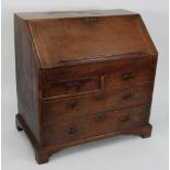 EIGHTEENTH CENTURY OAK BUREAU, of typical form with short drawers, pigeon holes, central cupboard