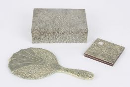 A shagreen covered hand-held mirror, of Art Deco Style the glass with bevelled edges, together