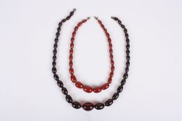 Two cherry amber coloured necklaces, one set of graduated beads with amber content, the other