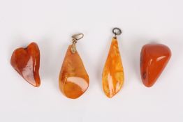 Four pieces of amber, mainly late 19th century comprising two pendants, one brooch and an