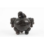 A Chinese black quartz carved globular vase and cover, circa 1900, carved with incised dogs of