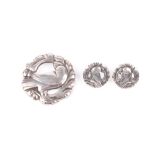 A Georg Jensen Sterling silver suite, comprising circular brooch and matching earrings decorated