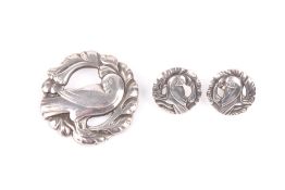 A Georg Jensen Sterling silver suite, comprising circular brooch and matching earrings decorated