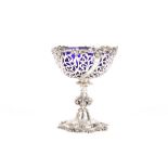 A Victorian pierced silver bon-bon dish with blue glass liner, hallmarked London 1865, the rim