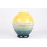 A Moorcroft vase, of globular form, with yellow and graduated blue colouring, with impressed W.