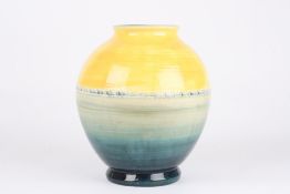 A Moorcroft vase, of globular form, with yellow and graduated blue colouring, with impressed W.