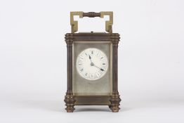 A Victorian brass repeater carriage clock, the circular enamel dial with Roman numerals, in a