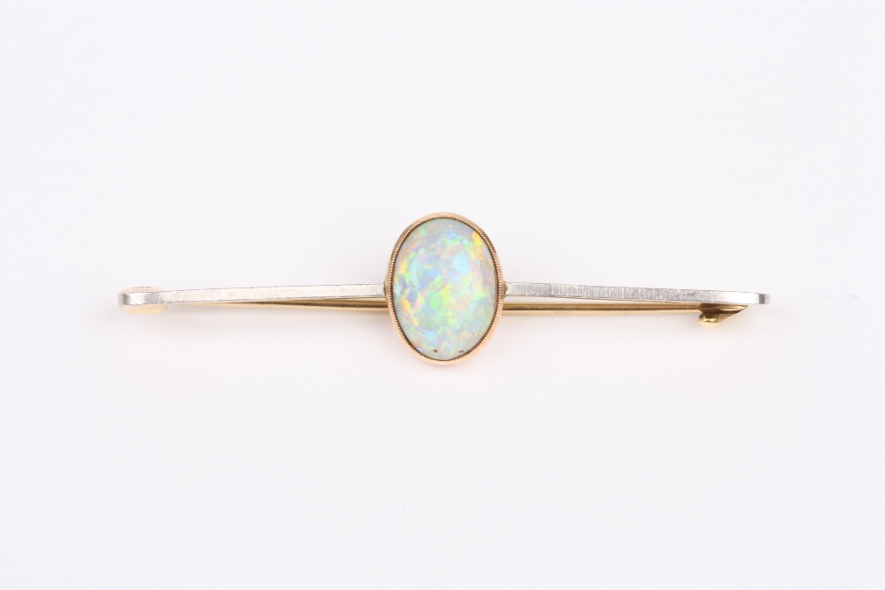 A Victorian 15ct gold and opal bar brooch, set with oval opal on a plain bar. 5cm long . Good